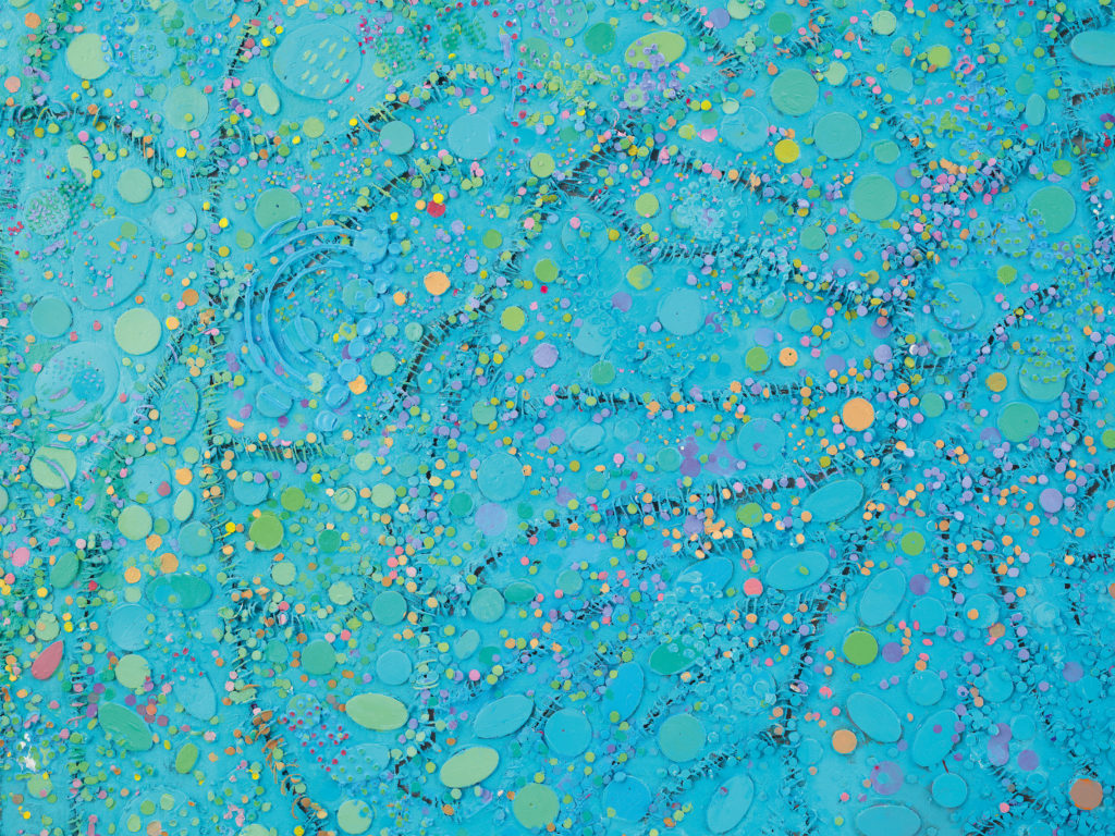 detail of stitched together canvas painted blue with green and yellow polka dots.